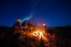 (Photo: Jaroš Obu) Watching the northern lights by the campfire.